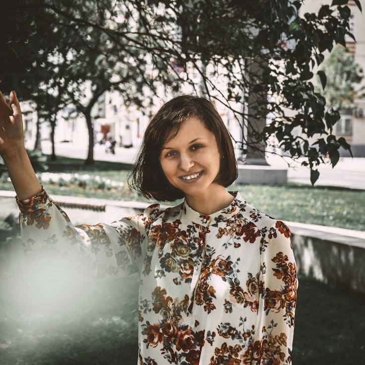 Mira Das, Lead Design Curator at MeadowLaneHub, reviewing corporate floral arrangements